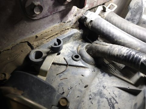 1996 Ford Bronco - Engine bay components, including hoses and a mounting bracket, are shown in this close-up view.