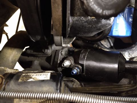 1996 Ford Bronco - Close-up view of a vehicle's power steering rack and pinion assembly.