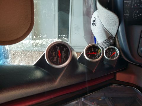 1996 Ford Bronco - Interior view shows three aftermarket gauges mounted on the dashboard, including water temperature and oil pressure.