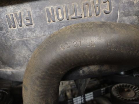 1996 Ford Bronco - A hose in the engine bay is stamped with the date 03 27 96, suggesting it is from a 1996 Ford Bronco.