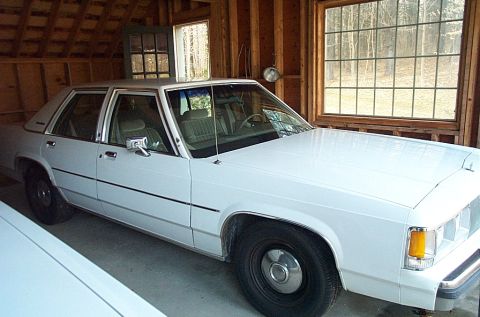 1991 Ford Crown Victoria LTD - White 1991 Ford Crown Victoria LTD sits inside a wooden garage with large windows.