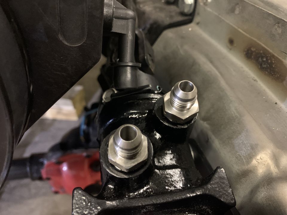 Close-up of power steering pump with two metal fittings