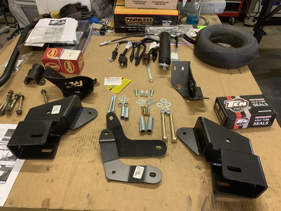 Various vehicle parts and accessories, including brackets, bolts, and axle tube seals