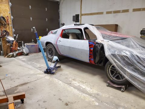 1979 Chevrolet Camaro - A 1978 Chevrolet Camaro is in a garage, partially covered and prepped for bodywork, with tools and equipment around it.