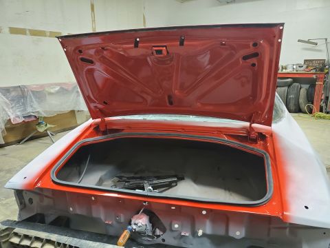 1979 Chevrolet Camaro - The trunk of a 1979 Chevrolet Camaro is open, revealing the interior and a jack tool.