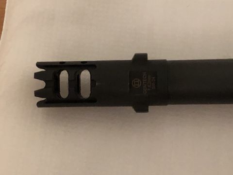 1995 Mercury Grand Marquis - A black muzzle brake with visible text indicating it is for 7.62x39 caliber ammunition and has a 5/8-24 thread size.