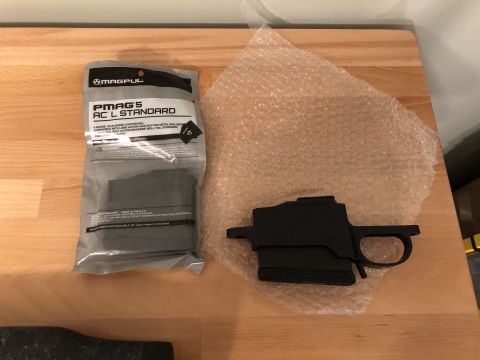 1995 Mercury Grand Marquis - Magpul PMAGS AC L STANDARD magazine package and a black chassis are on a wooden surface.