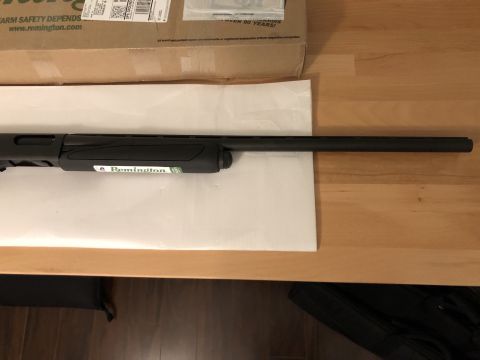 1995 Mercury Grand Marquis - Close-up of a Remington shotgun barrel and receiver, with a box in the background.