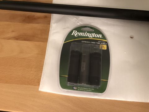 1995 Mercury Grand Marquis - A package of Remington choke tubes is displayed on a wooden surface.