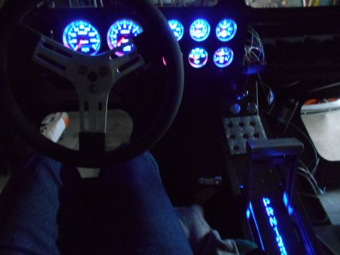 1992 Ford Bronco - Interior view of a vehicle's dashboard with custom gauges and illuminated gear shifter.