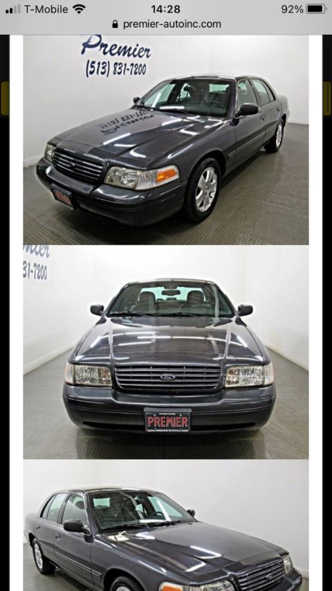 1995 Mercury Grand Marquis - Front view of a dark sedan with a Premier license plate and Ford emblem.
