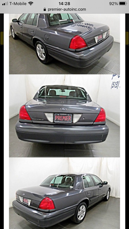1995 Mercury Grand Marquis - Rear view of a dark gray sedan with a license plate frame that reads 'PREMIER'.