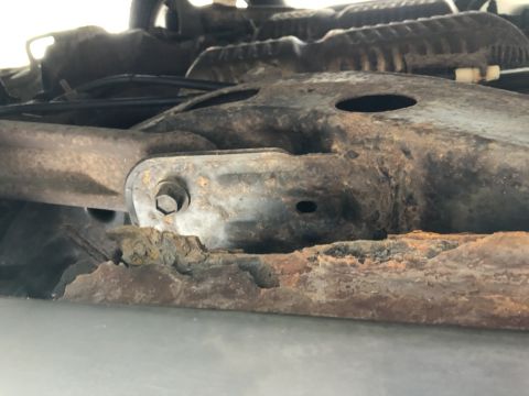 1995 Mercury Grand Marquis - Close-up view of a heavily rusted vehicle frame component, showing signs of significant corrosion and a Supermotors.net watermark.
