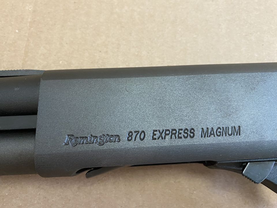 Black Remington 870 Express Magnum shotgun receiver with engraved text