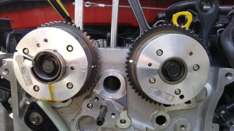 2010 Hyundai Genesis - Close-up view of engine timing gears, showing mechanical components and some oil staining.