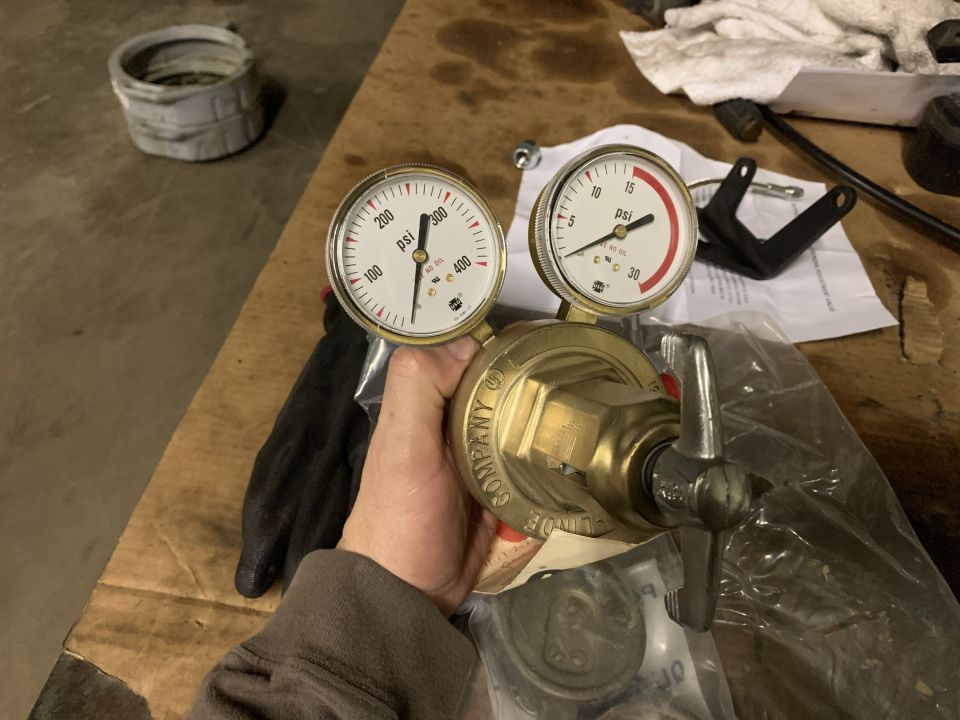 Pressure regulator with two gauges, one reading up to 400 psi and the other up to 30 psi. Text on regulator reads "COMPANY, G", "ILLINOIS"