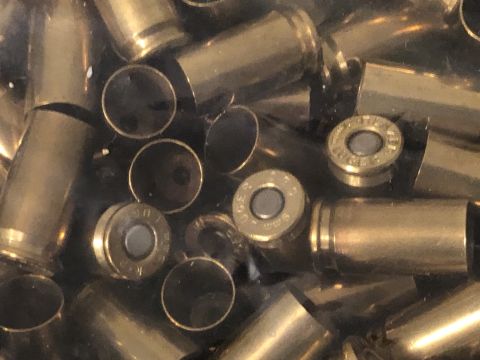 1995 Mercury Grand Marquis - A collection of spent brass bullet casings fills the frame, showing various angles and states of use.