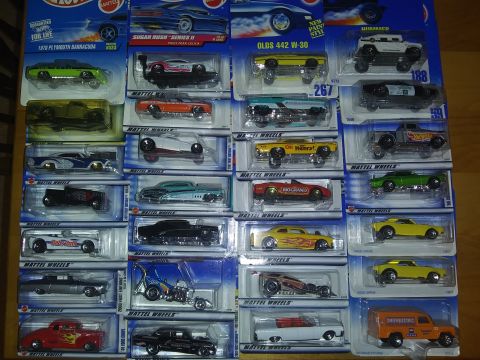 1989 Ford F-350 - A variety of Hot Wheels toy cars are displayed in their original packaging, different models and designs.