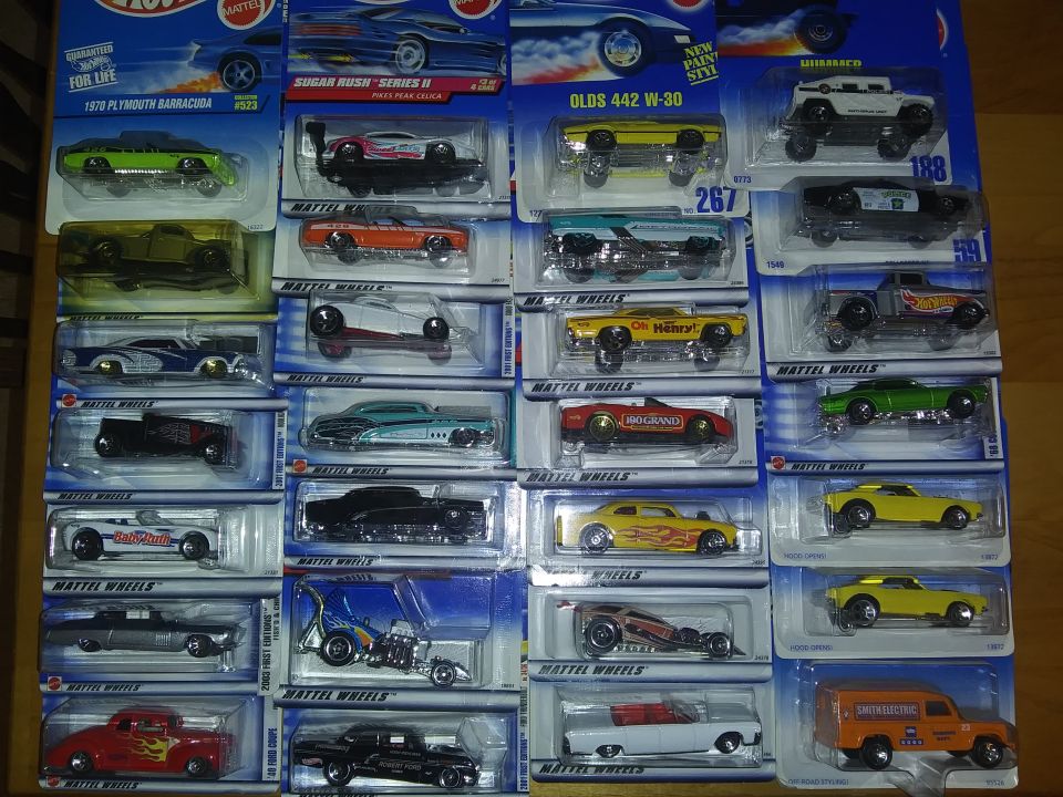 Collection of Hot Wheels toy cars in packaging, various models