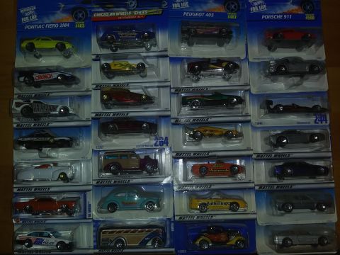 1989 Ford F-350 - A display of various Hot Wheels toy cars, each in its blister pack, covering multiple rows.