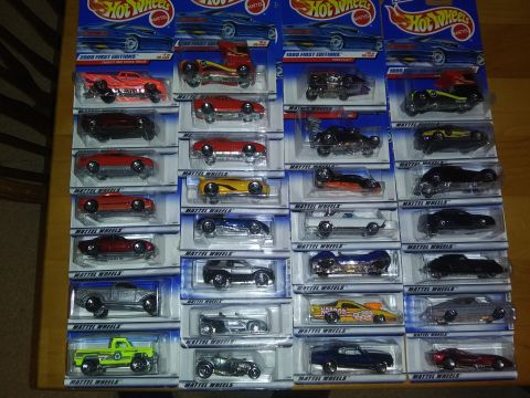 1989 Ford F-350 - A large collection of Hot Wheels toy cars, neatly arranged in their original packaging, fills the frame.