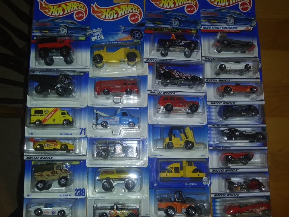 Collection of Hot Wheels toy cars in blister packs, arranged in rows