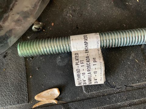 1996 Ford Bronco - A threaded rod with a label indicating its specifications is visible on a dark, textured surface.