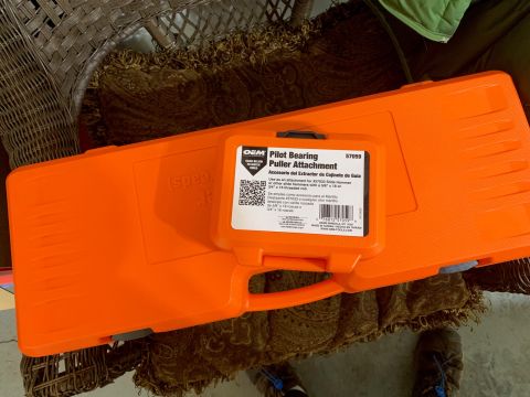 1996 Ford Bronco - An orange tool case containing a Pilot Bearing Puller Attachment is shown, with text on the label providing product information.