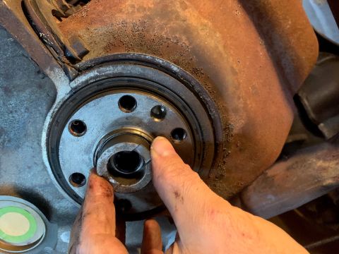 1996 Ford Bronco - Hands manipulate a split collar on a shaft, part of a larger mechanical assembly.