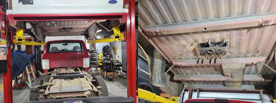 Red pickup truck bed and frame elevated on a red car lift, showing the underside