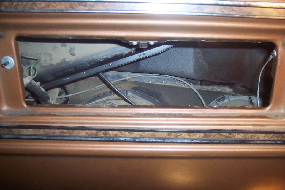 Copper-colored dashboard with an open cavity revealing heater core, ducting, and wires