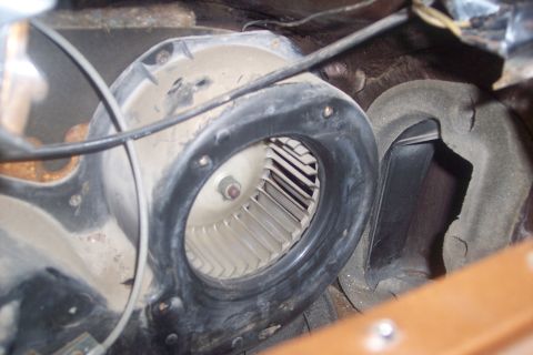 1978 Ford Bronco - The interior of a vehicle's HVAC system is visible, focusing on the blower motor.