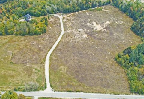 1992 Jeep Wrangler - An aerial perspective captures a secluded house accessed by a dirt path through a vast, undeveloped landscape.