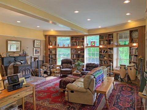 1992 Jeep Wrangler - A cozy living room features a fireplace, extensive bookshelves, and comfortable seating arrangements.