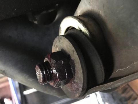1996 Ford Bronco - A close-up view of a greased suspension bolt and washer assembly.