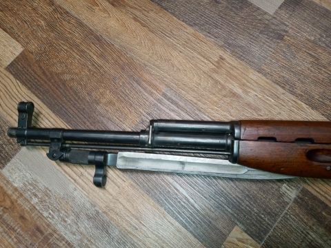 1994 Ford Bronco - Close-up view of a rifle's front end, showing the barrel and attached bayonet.