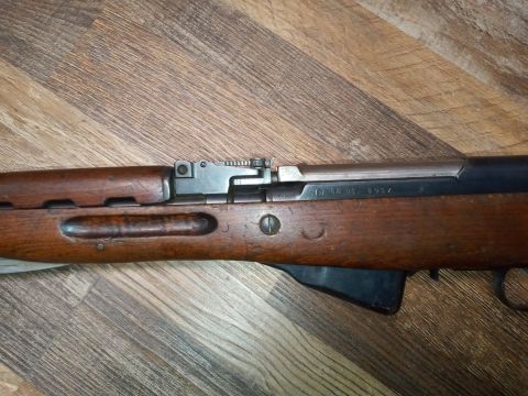 1994 Ford Bronco - Close-up view of a rifle receiver showing markings and wooden stock on a wooden surface.