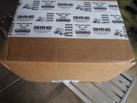 1992 Ford Bronco - A cardboard box is covered in tape images and text related to the DeLorean Motor Company.