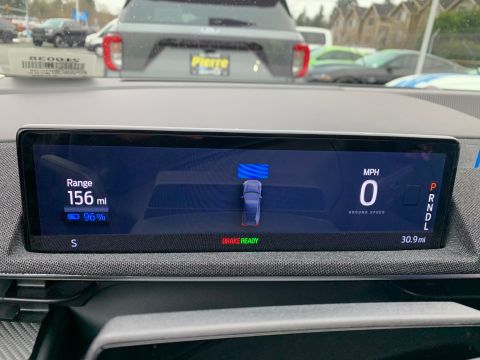 2021 Ford Mustang - The digital dashboard displays the vehicle's range, battery charge, and speed, indicating it is currently stationary.