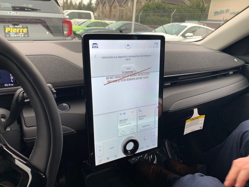 2021 Ford Mustang Mach-E interior showing the large touchscreen display with a caution message