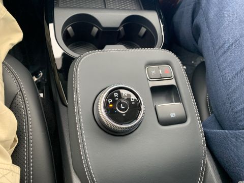 2021 Ford Mustang - The interior of a car displays a rotary gear selector and a parking brake button.
