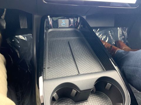 2021 Ford Mustang - The center console features a wireless charging pad and dual USB ports, indicating a modern vehicle interior.