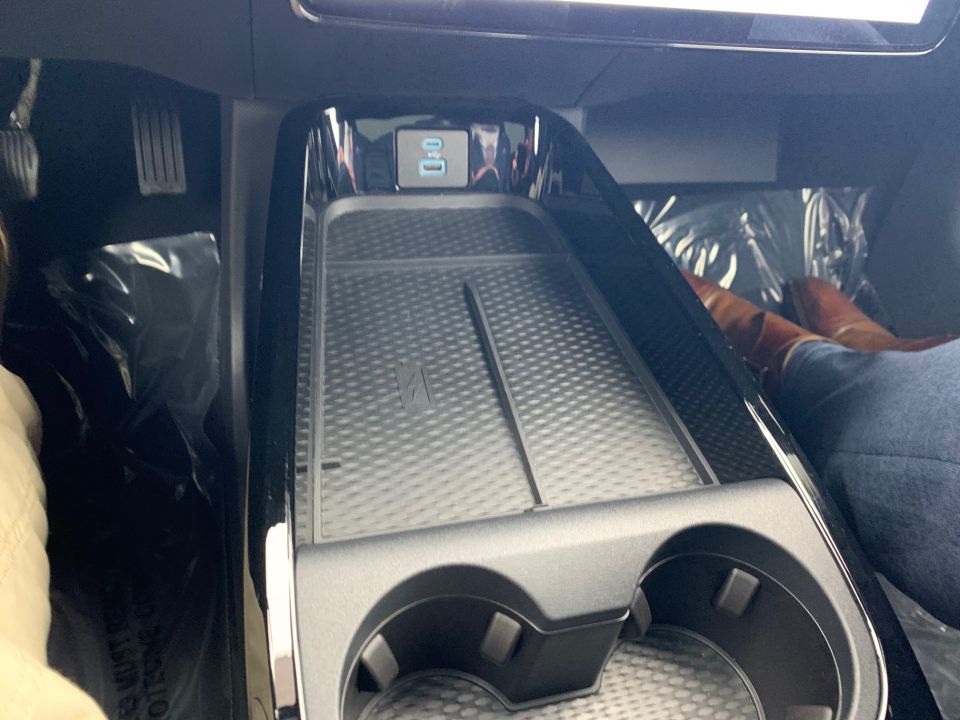 Interior view of car's center console with wireless charger and USB ports