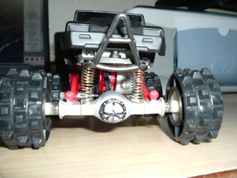 1989 Ford Bronco - Close-up view of the rear suspension and axle of a toy truck.