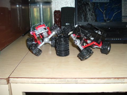 1989 Ford Bronco - Two toy RC rock crawlers are positioned on a desk next to a laptop.