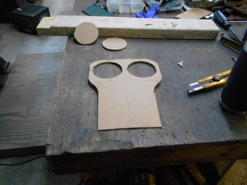 1992 Ford Bronco - A cardboard template with two circular cutouts sits on a workbench, ready for modification.