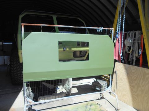 1992 Ford Bronco - A vehicle body panel is being worked on in a garage, with tools and chains visible in the background.