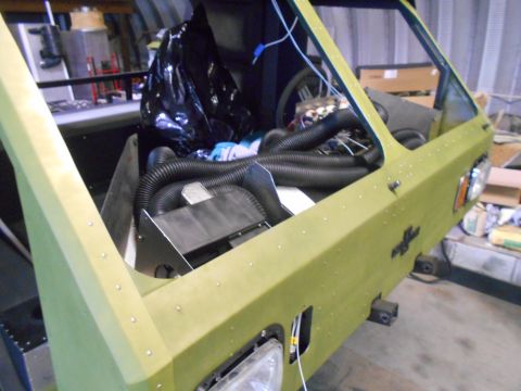 1992 Ford Bronco - Vehicle interior under construction with engine components and hoses visible.