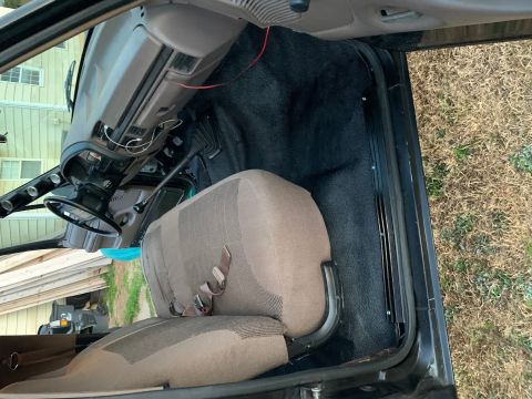 1996 Ford Bronco - The interior of a 1996 Ford Bronco, cloth seats and a dashboard with aftermarket gauges.
