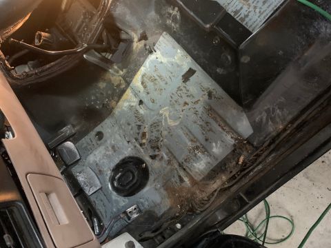 1996 Ford Bronco - Interior floor of a vehicle, showing signs of wear and rust.